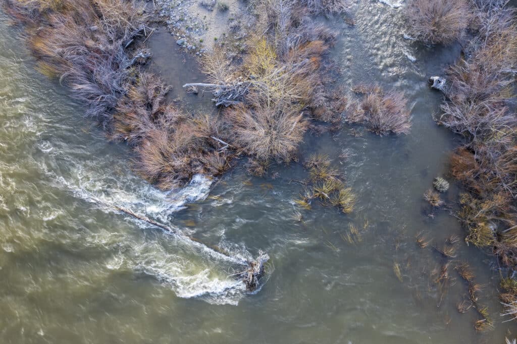 An aerial photograph showing high water levels of the Truckee River spilling over the river banks.