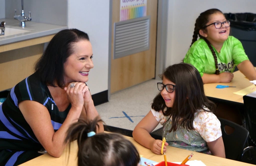 A photo of Washoe County Superintendent Susan Enfield visiting with students in a school classroom.