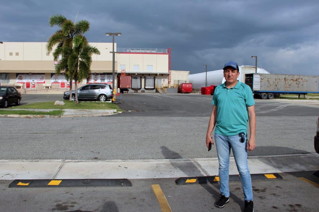 A photo of Salinas resident and environmental activist Victor Alvarado Guzmán standing in a parking lot of a shopping center.