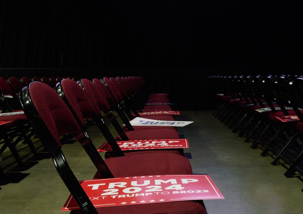A photo of empty, red seats with Trump 2024 flags.